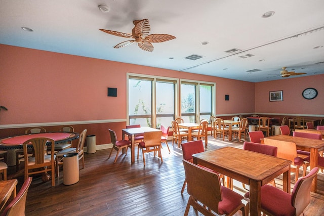 dining area with ceiling fan and dark hardwood / wood-style floors