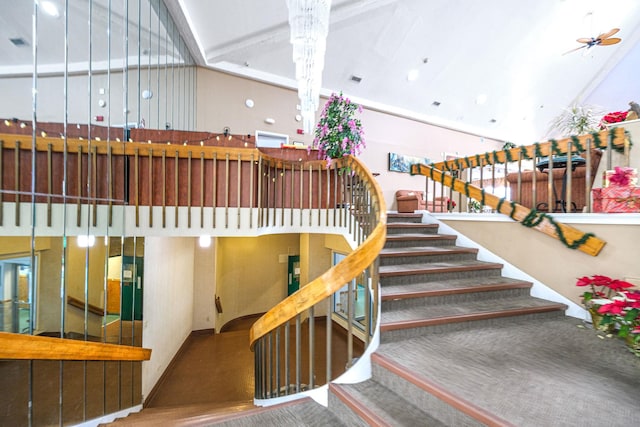 staircase featuring ceiling fan