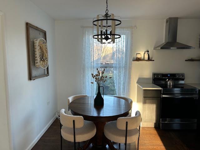 dining room featuring dark hardwood / wood-style flooring and an inviting chandelier