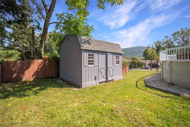 view of outbuilding featuring a mountain view and a yard