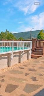 view of pool featuring a water view