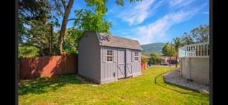 view of outbuilding featuring a mountain view and a yard