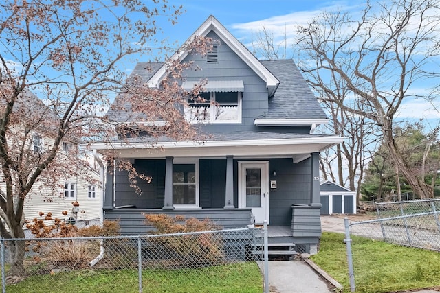 view of front of home featuring a garage, an outdoor structure, and a front lawn