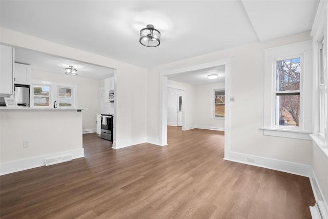 unfurnished living room with wood-type flooring