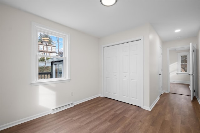 unfurnished bedroom with a closet and dark wood-type flooring