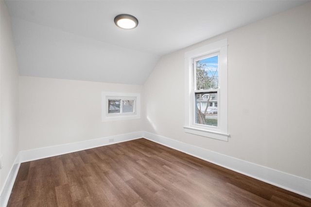 additional living space featuring vaulted ceiling and hardwood / wood-style flooring