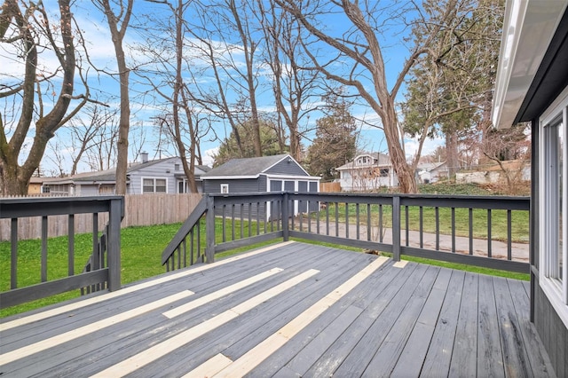 wooden deck with a yard and an outbuilding