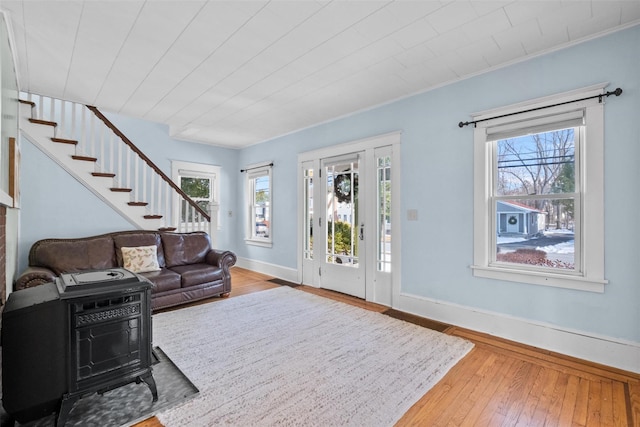 living room featuring wood-type flooring and a wood stove