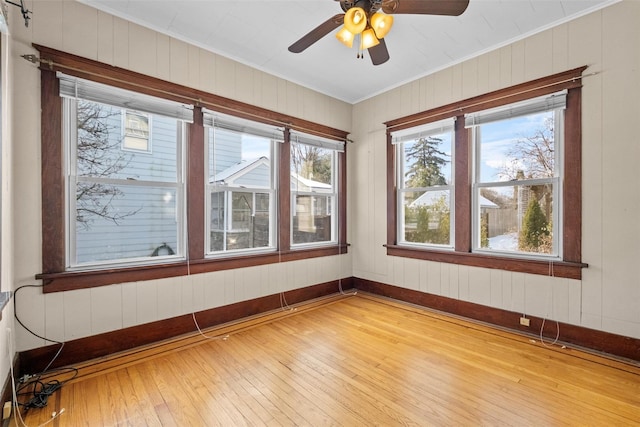 unfurnished sunroom featuring ceiling fan