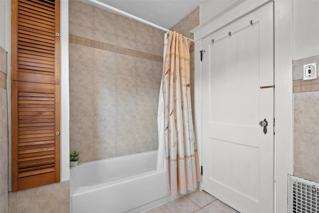 bathroom with tile patterned floors and shower / bath combination with curtain