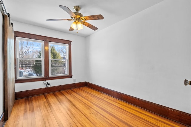 spare room with hardwood / wood-style flooring and ceiling fan