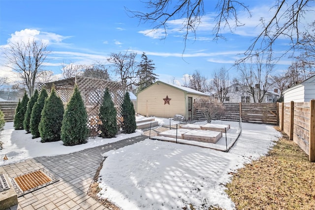 snow covered patio with an outbuilding