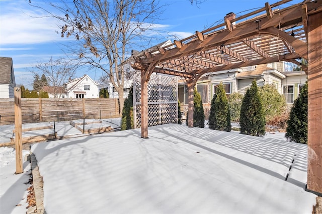 snowy yard with a pergola