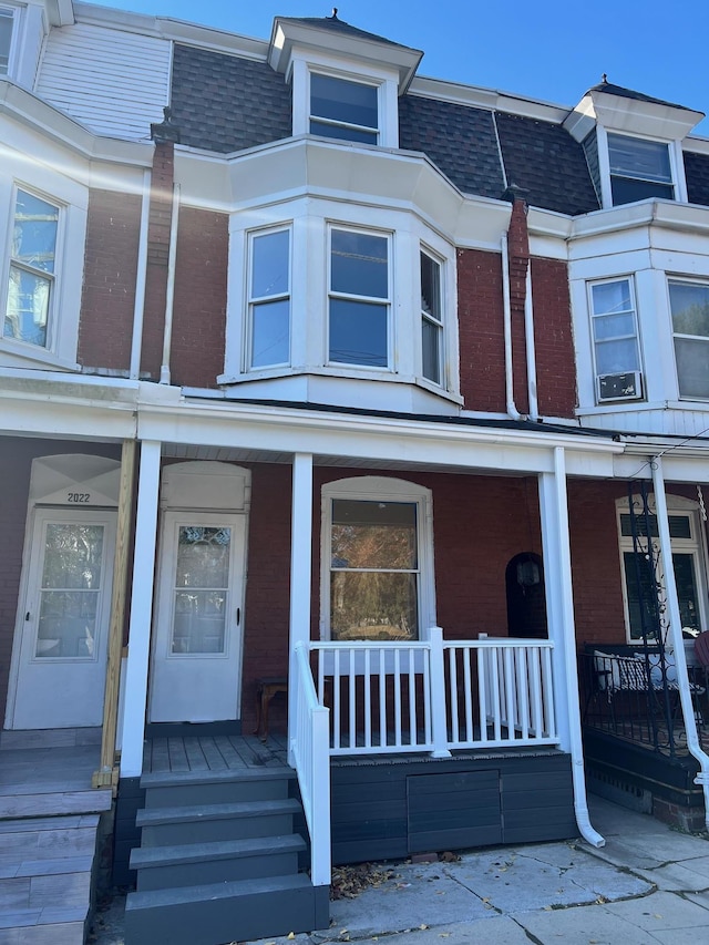 view of exterior entry featuring covered porch