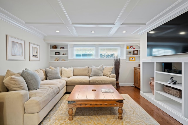 living area featuring built in features, coffered ceiling, wood finished floors, crown molding, and beam ceiling