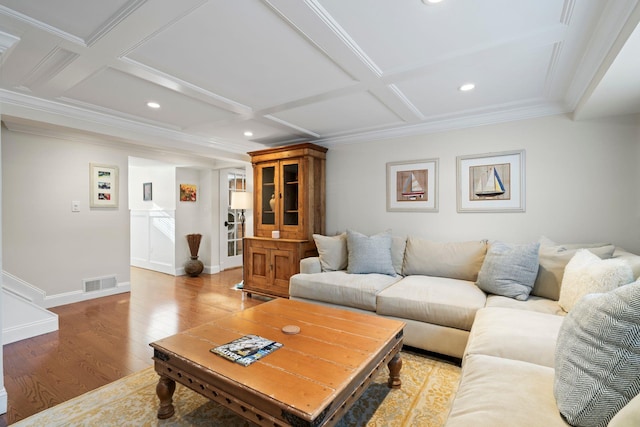 living room featuring baseboards, coffered ceiling, visible vents, and light wood finished floors