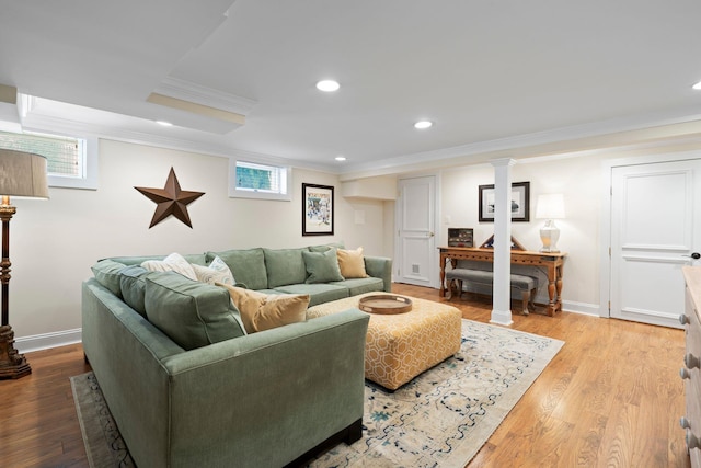 living area with light wood-style floors, baseboards, crown molding, and recessed lighting