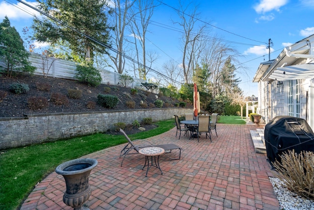 view of patio / terrace with outdoor dining area, area for grilling, and a fenced backyard