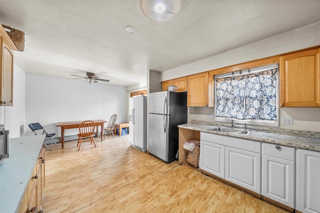 kitchen with stainless steel fridge, ceiling fan, sink, light hardwood / wood-style flooring, and white fridge with ice dispenser