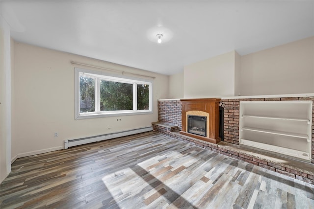 unfurnished living room with wood-type flooring and baseboard heating