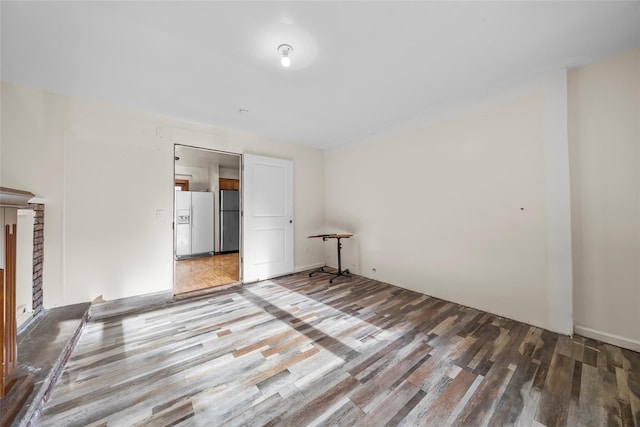 empty room featuring a fireplace and wood-type flooring