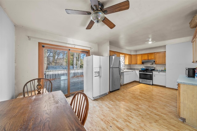 kitchen featuring ceiling fan, stainless steel appliances, and light hardwood / wood-style floors