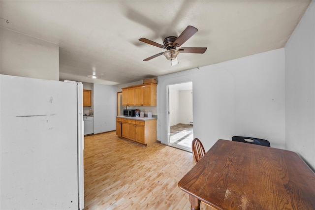 kitchen featuring ceiling fan, white fridge, and light wood-type flooring