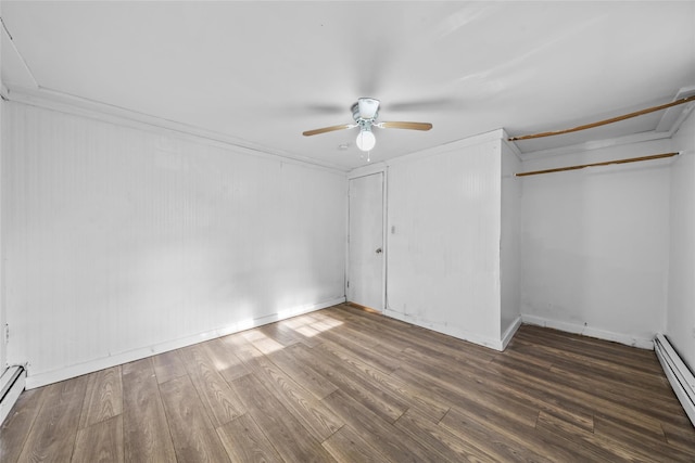 unfurnished bedroom featuring dark hardwood / wood-style floors, baseboard heating, ceiling fan, and ornamental molding