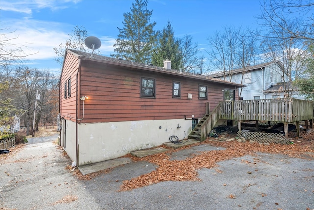 view of side of home with a wooden deck