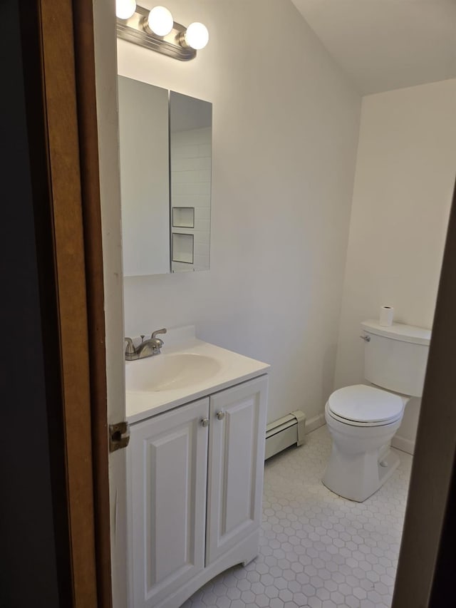 bathroom with vanity, tile patterned flooring, a baseboard radiator, and toilet