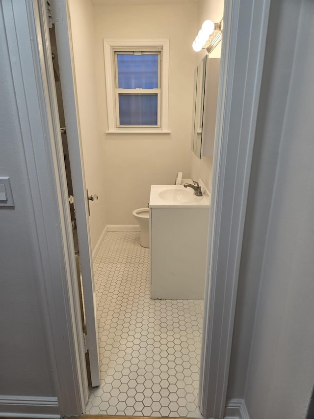 bathroom featuring tile patterned floors, vanity, and toilet