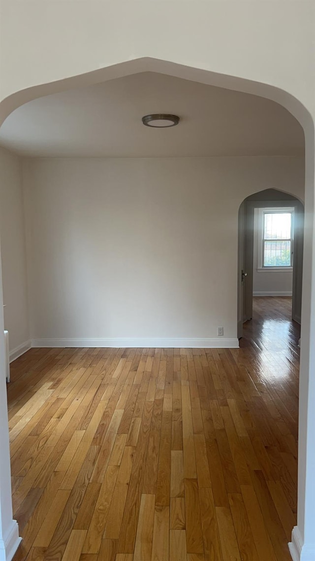 unfurnished room with hardwood / wood-style flooring