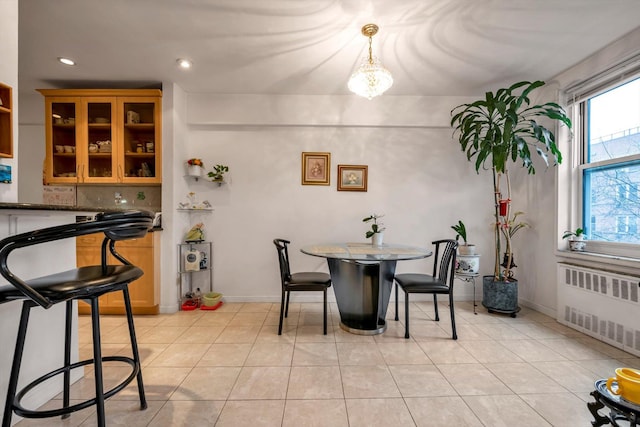 dining space with radiator heating unit and light tile patterned floors