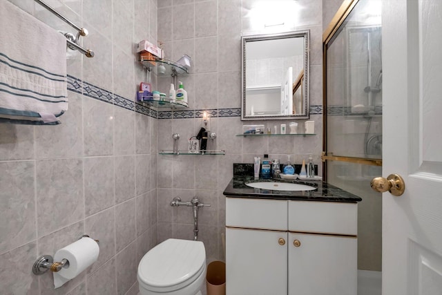 bathroom with backsplash, vanity, tile walls, and toilet