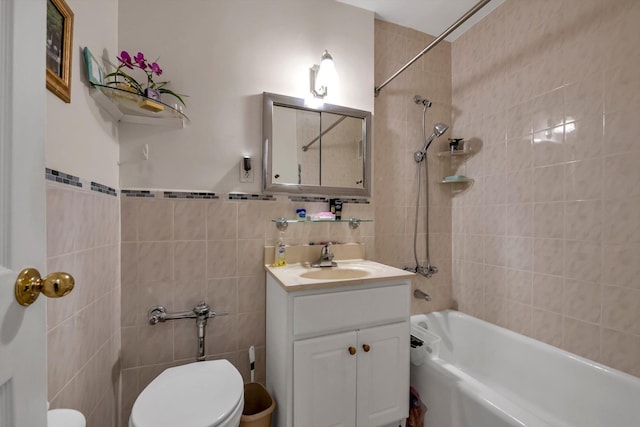 full bathroom with vanity, tiled shower / bath combo, tile walls, and toilet