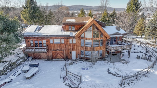 snow covered property featuring a deck with mountain view