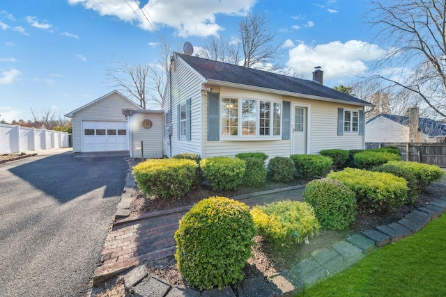 view of front of house with a garage and an outdoor structure