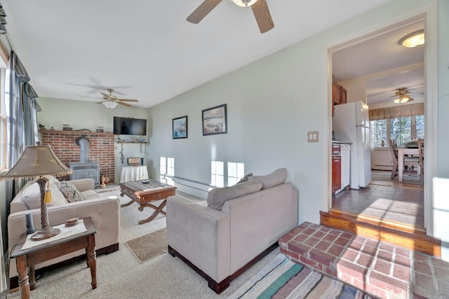 carpeted living room featuring a wood stove and a baseboard heating unit