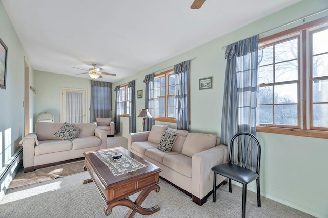 living room with ceiling fan, light colored carpet, and baseboard heating