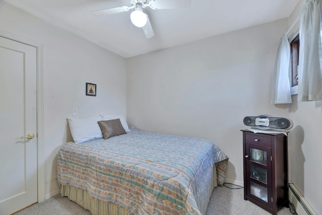 bedroom with ceiling fan, light colored carpet, and a baseboard heating unit