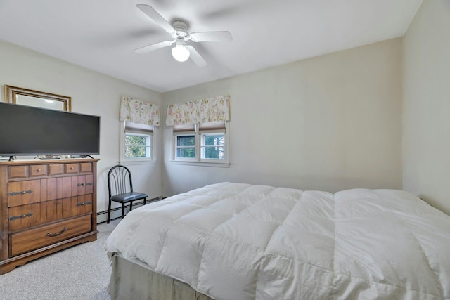 bedroom featuring carpet floors, ceiling fan, and a baseboard heating unit