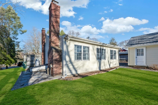 back of house with a lawn