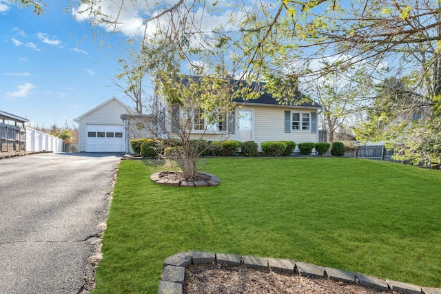 view of front of home featuring a front lawn and a garage