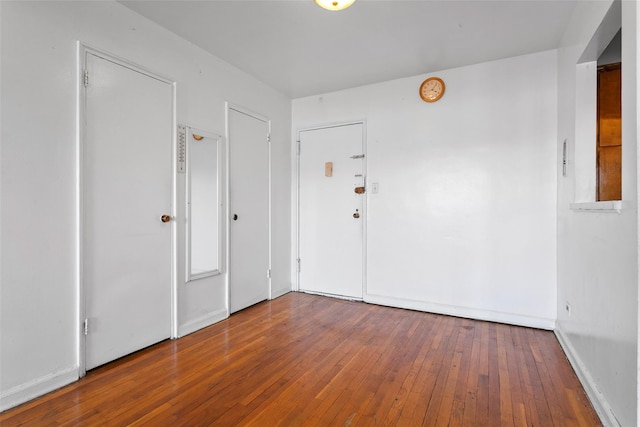 unfurnished room with wood-type flooring