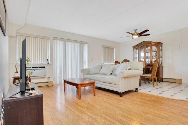 living room featuring light hardwood / wood-style floors, ceiling fan, and a baseboard heating unit