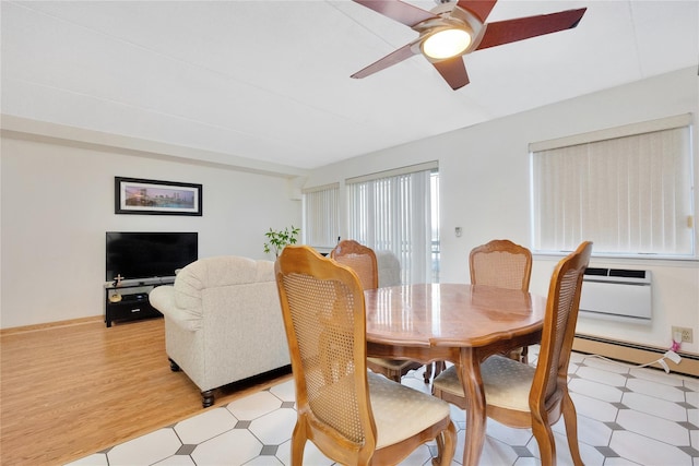 dining area featuring ceiling fan, baseboard heating, and light hardwood / wood-style flooring