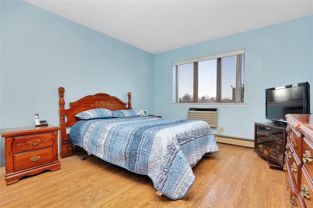 bedroom with an AC wall unit, light hardwood / wood-style floors, and a baseboard heating unit