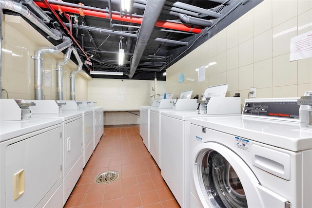 laundry room featuring separate washer and dryer and light tile patterned flooring