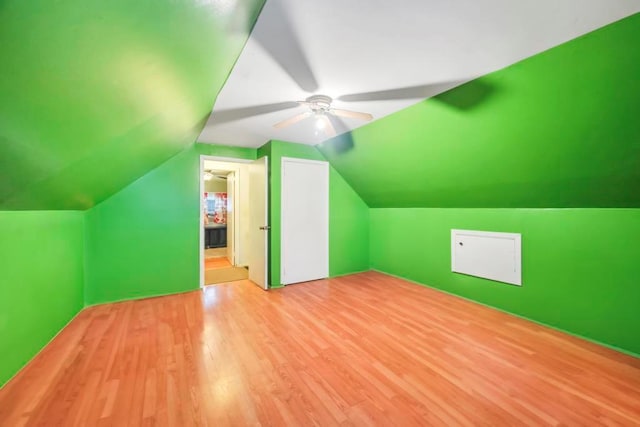 bonus room featuring light hardwood / wood-style flooring, vaulted ceiling, and ceiling fan