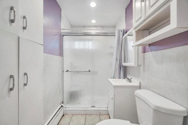 bathroom with vanity, toilet, an enclosed shower, and tile walls